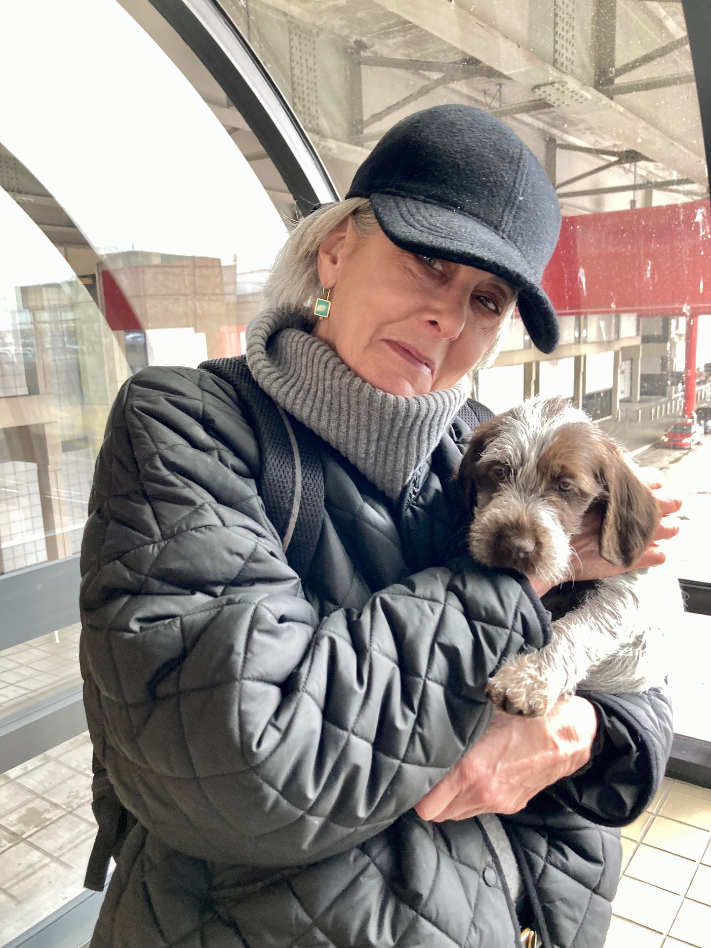 Jody Stein cradling a Wirehaired Pointing Griffon puppy